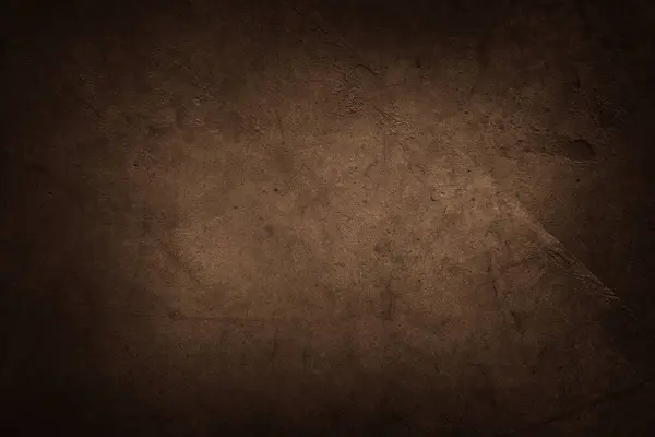 Brown textured concrete wall background. Dark edges