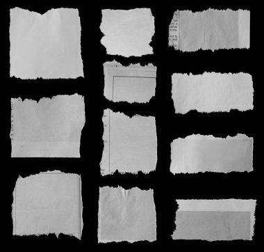 Siyah arka planda on bir parça yırtık gazete