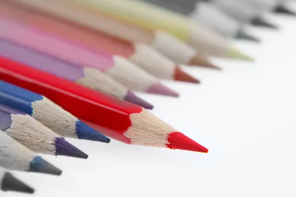 stock image One red pencil standing out from others