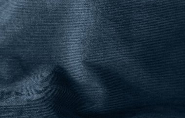 Dalgalanan mavi kumaş doku arkaplanının yakın plan görüntüsü