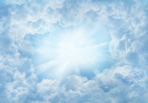 Bright rays shining in heavenly sky clouds