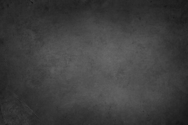 Grey textured concrete wall background. Dark edges
