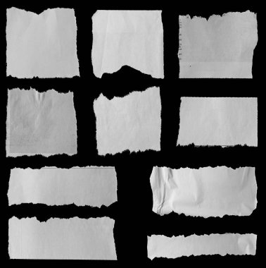 Siyah arka planda on parça yırtık gazete