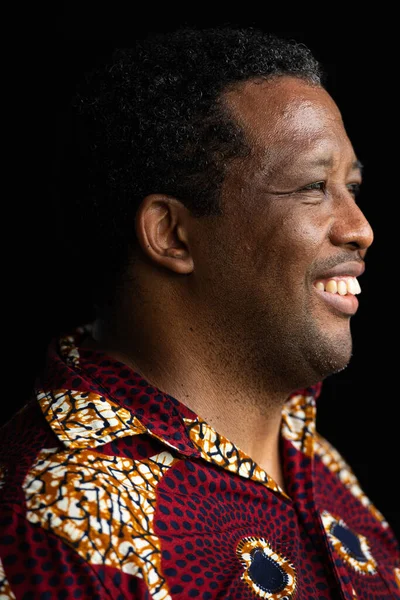 stock image Portrait of handsome African man against black background smiling