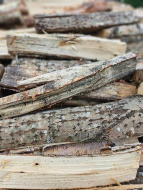 Closeup of Stacked Firewood Logs with Natural Bark Texture for Winter Heating Concept clipart