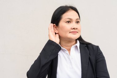 Beyaz arka planda iş kıyafetleri giymiş olgun Asyalı kadın portresi