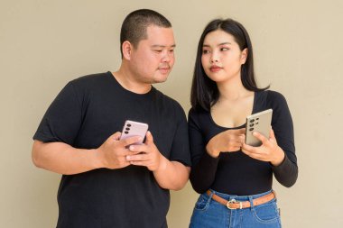 Duvarda asılı duran Asyalı genç bir çiftin portresi