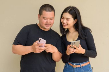 Duvarda asılı duran Asyalı genç bir çiftin portresi