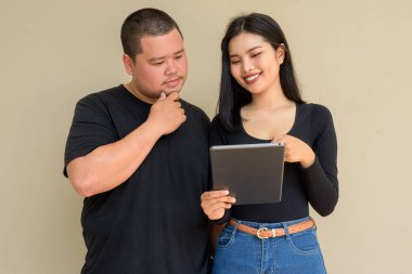 Duvarda asılı duran Asyalı genç bir çiftin portresi