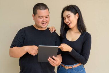 Duvarda asılı duran Asyalı genç bir çiftin portresi