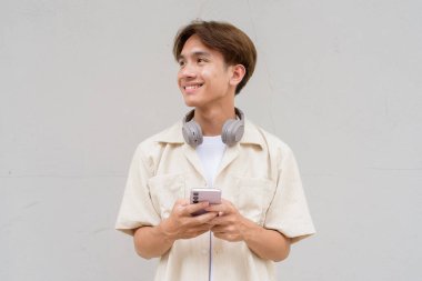 İkili olmayan sevimli Asyalı genç eşcinsel portresi düz arkaplanda