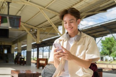 Tren istasyonunda iki kişilik olmayan genç Asyalı turist.
