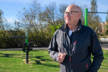 Portrait of a smiling senior man wearing sportswear outdoors.