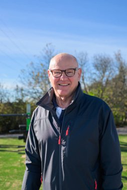 Portrait of a smiling senior man wearing sportswear outdoors.