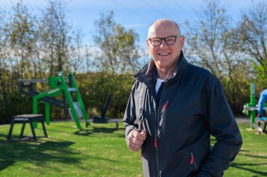 Portrait of a smiling senior man wearing sportswear outdoors.