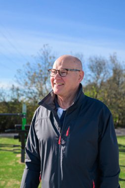Portrait of a smiling senior man wearing sportswear outdoors.