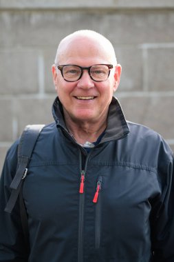 Portrait of a smiling Scandinavian senior man wearing sportswear in the city