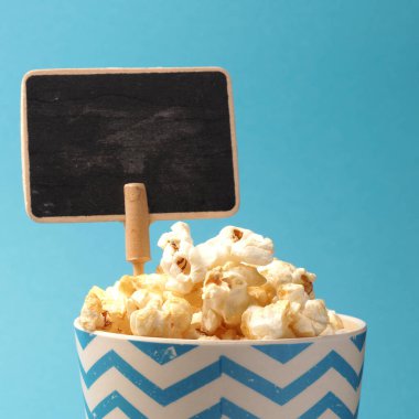 Metin veya resim için alanı olan mavi arkaplanda taze patlamış mısır