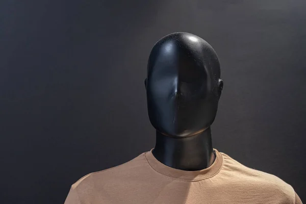 Face of mannequin on black background