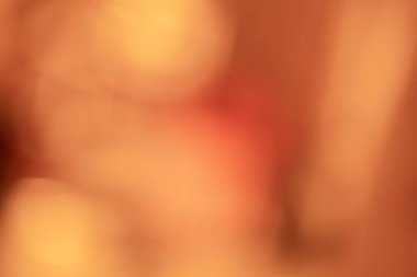 Soyut turuncu renk, parlayan güneş ışığıyla bulanık arkaplan