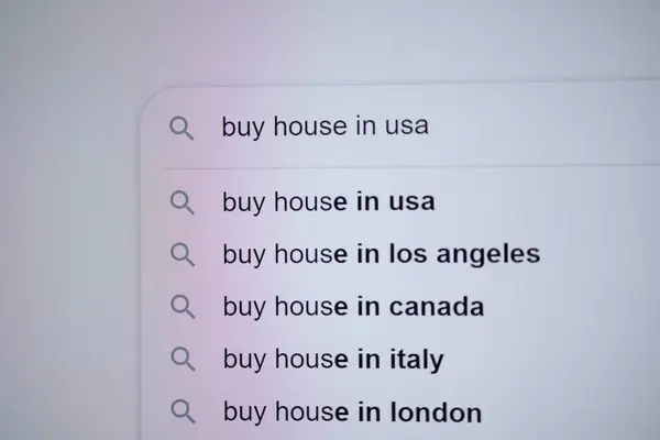 A digital screen showing search queries for buying houses in various locations like the USA, Los Angeles, Canada, Italy, and London, reflecting global real