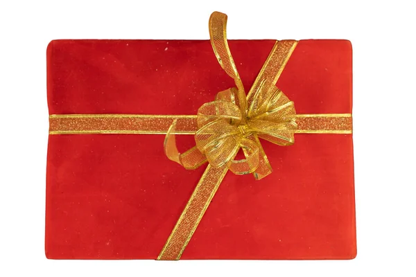 白い背景に金のリボンで結ばれた赤いギフトボックスは お祝いのクリスマスシーズン中に贈り物の伝統を表しています ロイヤリティフリーのストック画像