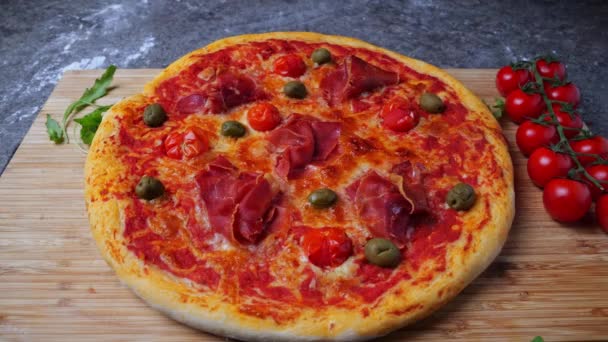 Pizza Met Prosciutto Tomaat Olijven Arugula Bladeren Vallen Langzame Beweging — Stockvideo