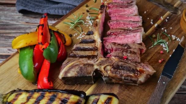 Bone Beef Steak Grilled Sliced Grilled Vegetables Rotate Wooden Cutting — Stock Video
