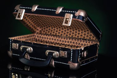 Retro, vintage open suitcase on a dark background