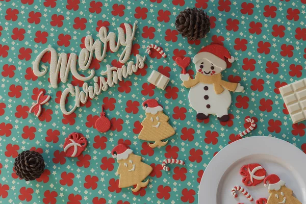 甘いクリスマスクッキーとキャンディーのイメージ テーブルの上にチョコレートメリークリスマステキスト — ストック写真