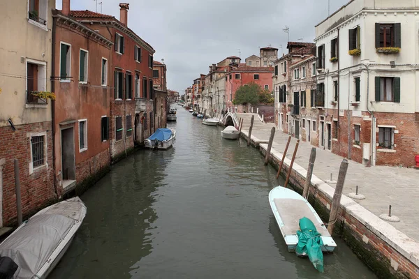 Venedik, İtalya - 26 Nisan 2019 Venedik 'teki renkli tarihi binalar arasındaki dar bir kanalın tipik görüntüsü