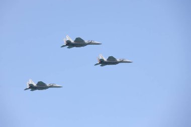 TEL AVIV, ISRAEL - April 15, 2021: Israeli Air Force F-15 planes fly in formation over the Mediterranean Sea as seen from a Tel Aviv beach. Tel Aviv Air Show dedicated to Israel's 2021 Independence Day clipart