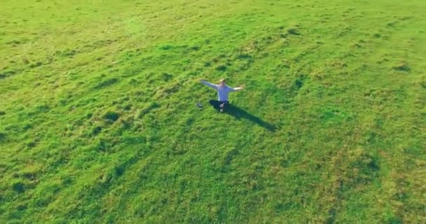 Aerial View Point Low Orbital Flight Man Seated Green Grass — Stock Video