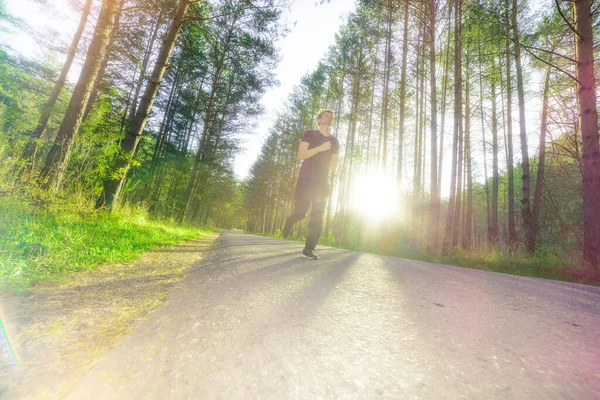 stock image Running man jogging in city park at beautiful summer day. Sport fitness model caucasian ethnicity training outdoor.