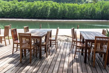 Dining table on the wooden bridge by the water