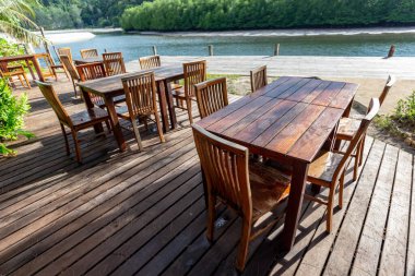 Dining table on the wooden bridge by the water