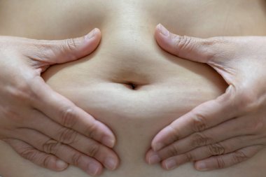 Navel of a teenage girl, front view close-up