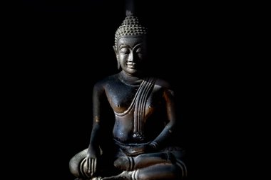 Old Buddha statue in the dark