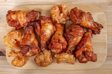 BBQ chicken drumsticks grilled on wooden floor