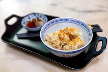 Pork dumplings topped with fried garlic