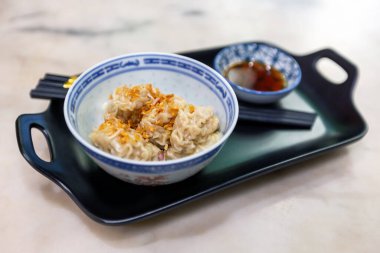 Pork dumplings topped with fried garlic