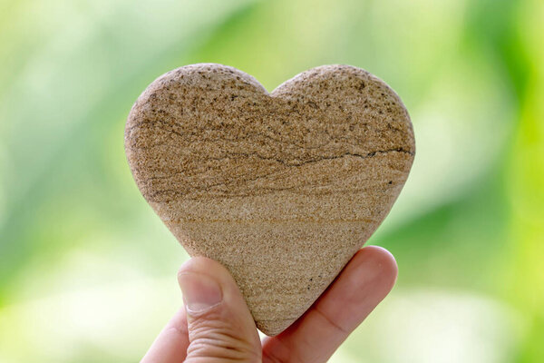 heart shaped stone on a sand