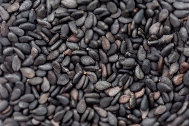 black sesame seeds on a black background.