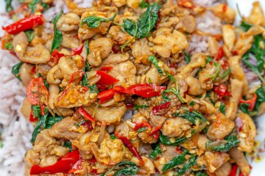 Baharatlı kızarmış tavuk, fesleğen yaprağı ve kırmızı pilav.