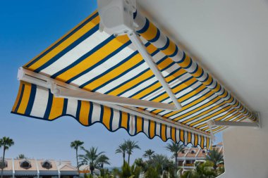 retractable manual awning above apartment balcony clipart