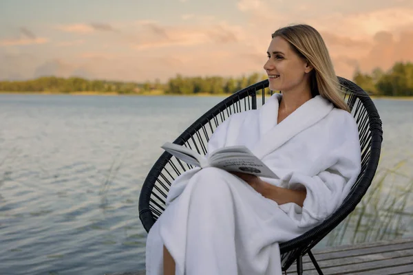 Woman White Bathrobe Read Book Chair Lake Footbridge Enjoy Warm — Stock Photo, Image