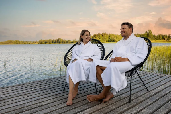 Happy Couple White Bathrobes Relaxing Wooden Lake Footbridge Spa Treatments — Stock Photo, Image