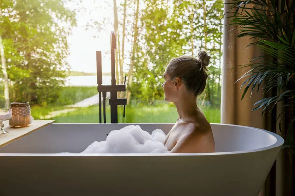 Young Woman Relaxing Bathtub Full Foam Looking Out Window Home — Stock Photo, Image