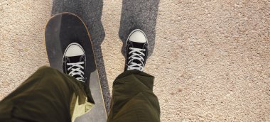 Asfaltta kaykay süren bir adam. Sokak kaykayı. POV, kopyalama alanı olan pankart