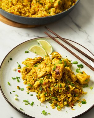 Yellow Curry rice dish with chicken and egg, cilantro, chilli and and spices. High quality photo